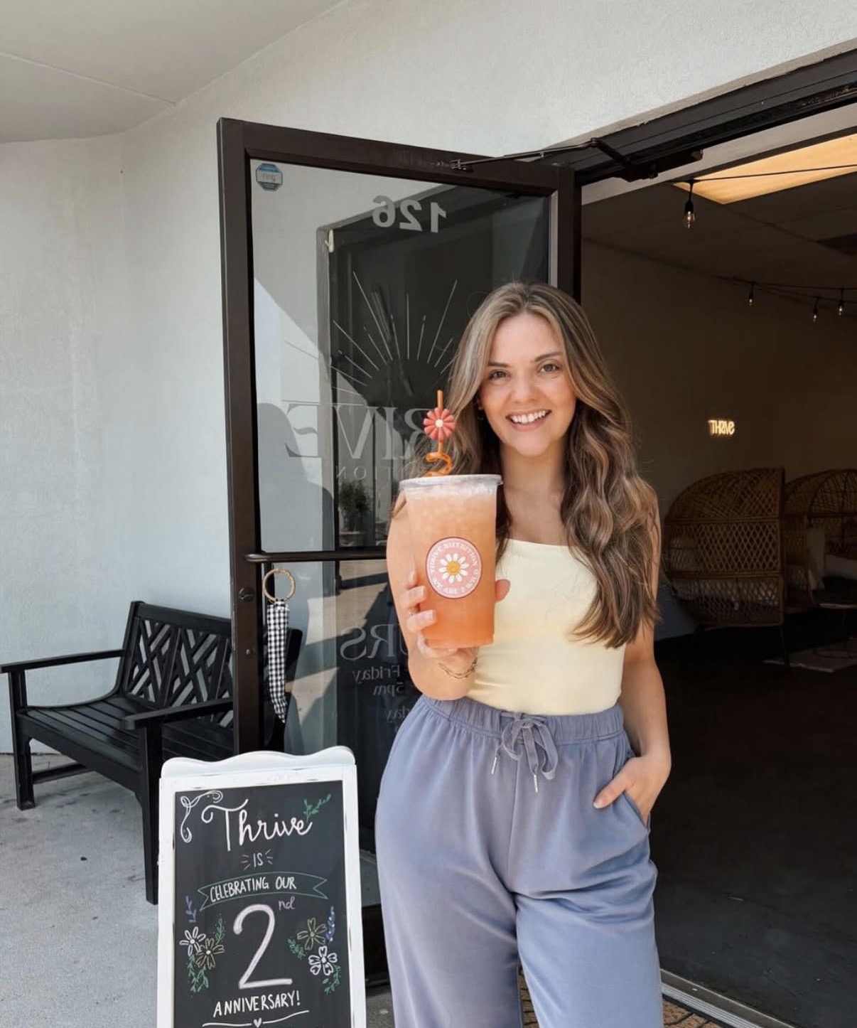 Gabby, owner of Thrive Nutrition, smiling behind the counter of her Beulaville shop